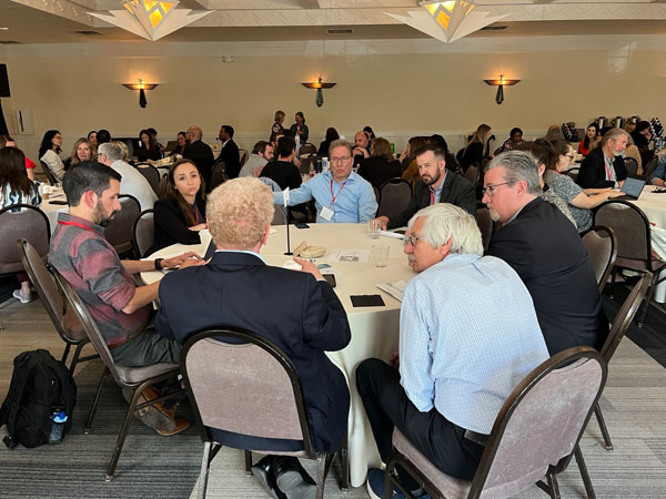 People sitting around table in banquet hall.