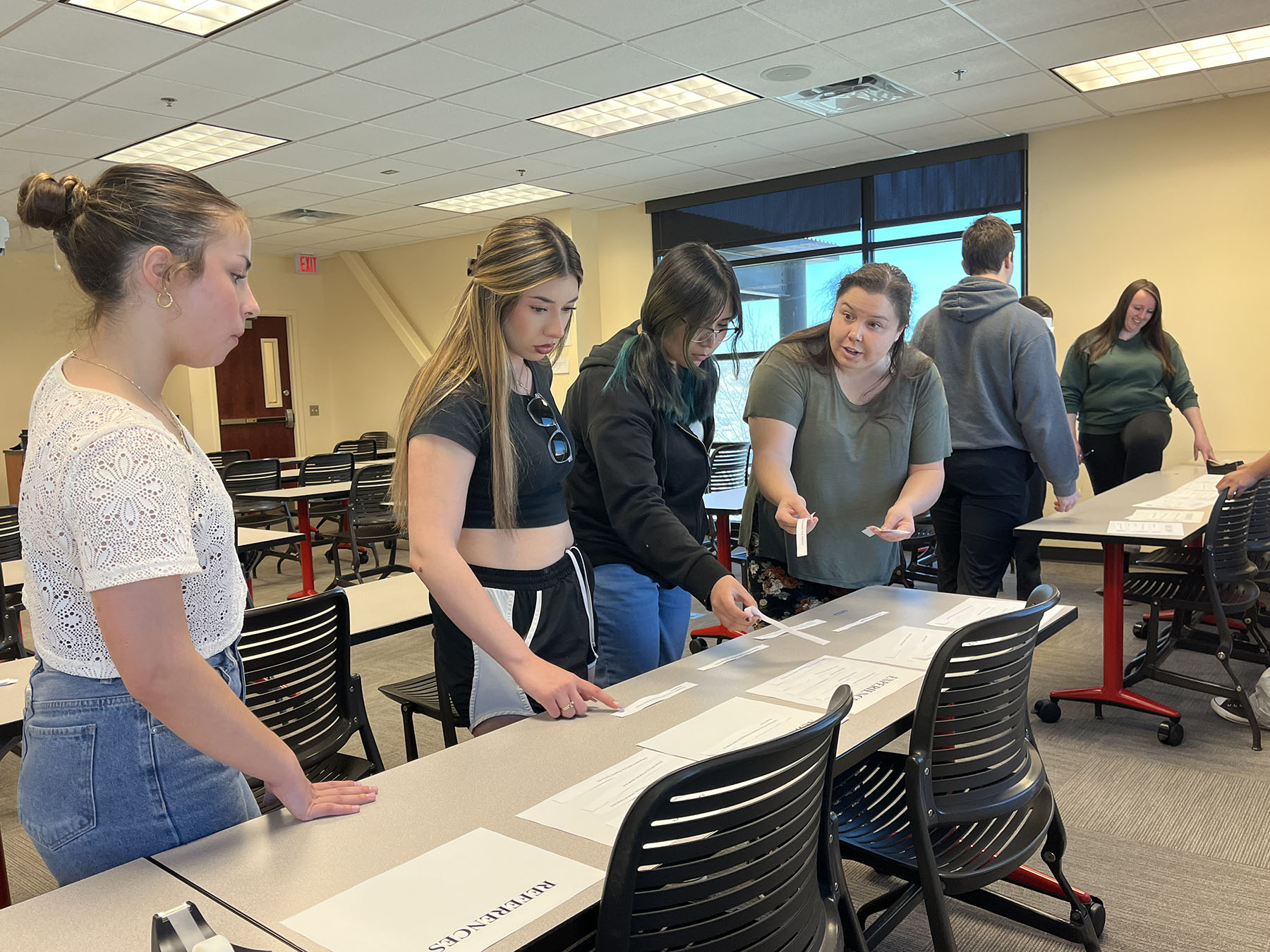 High school students attend to a dummy in a hospital bed