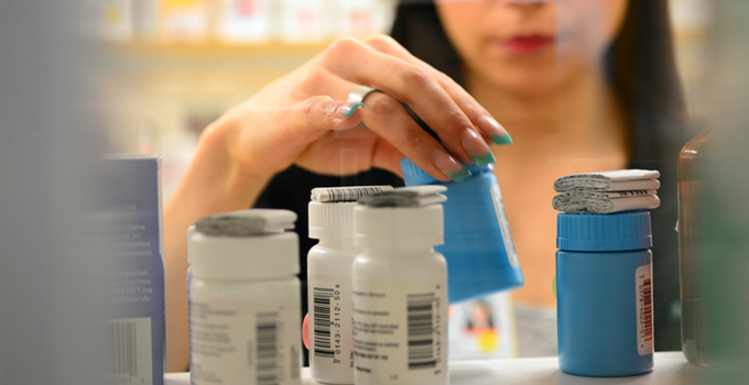 Person in pharmacy looking for medications.