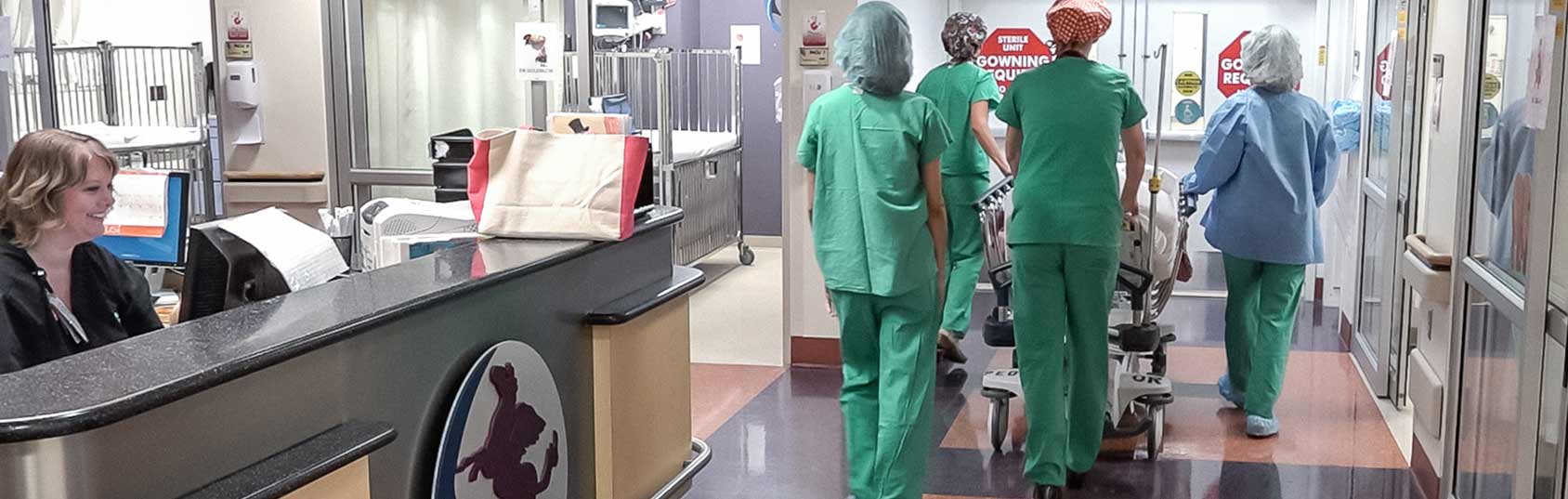 child being wheeled to operating room