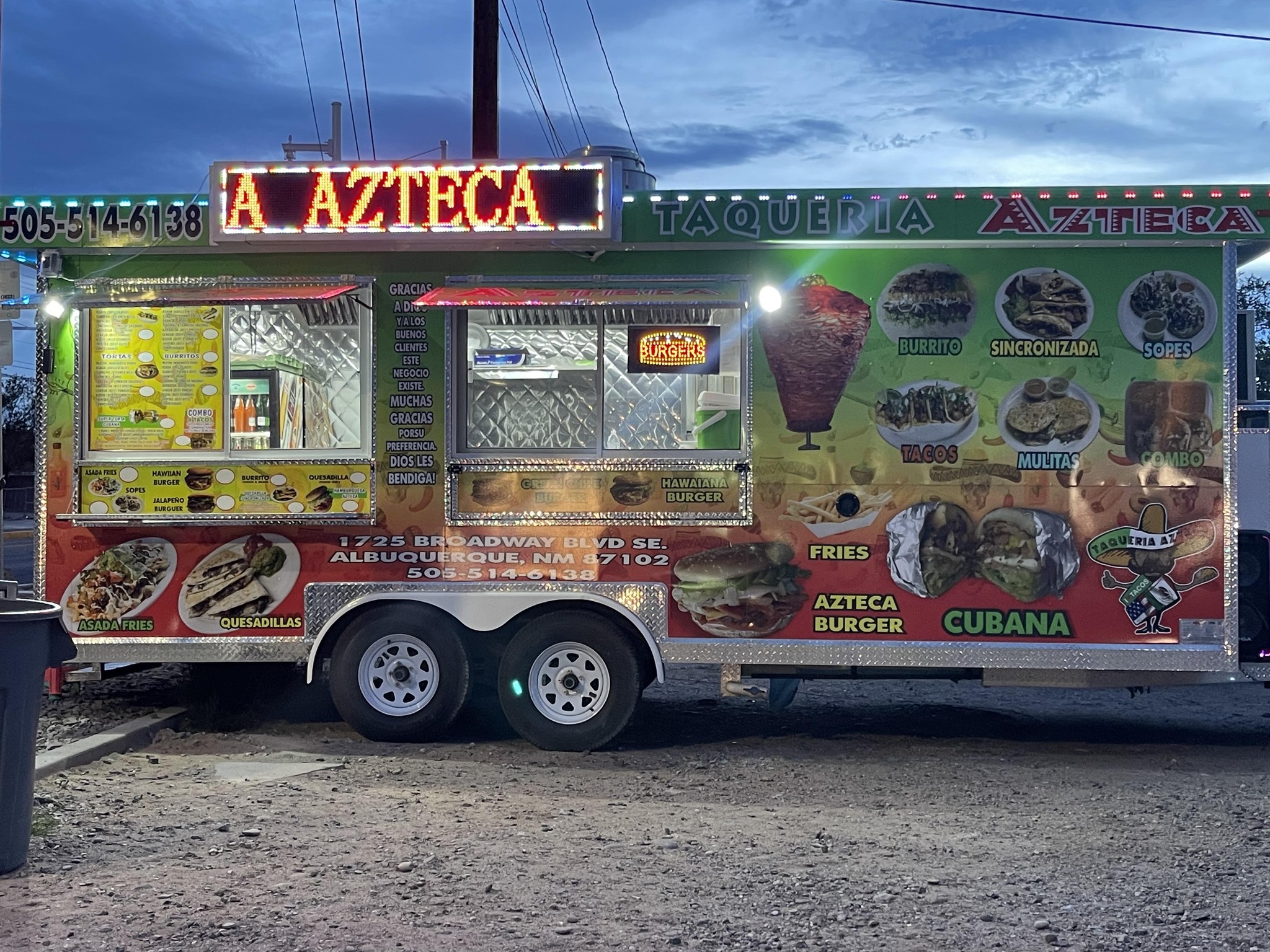 The Rezzy House food truck with its lights on at dusk