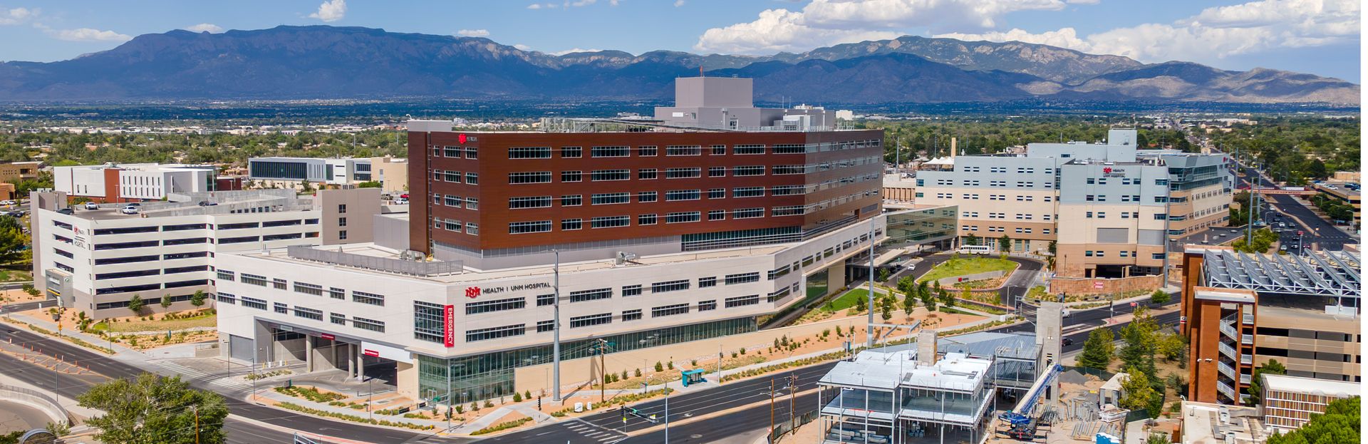 UNM Hospital Critical Care Tower with mountain backdrop.