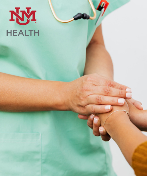 Patient's hands held by health care professional.