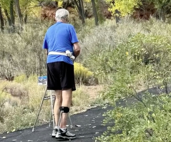 Man walking with walker.