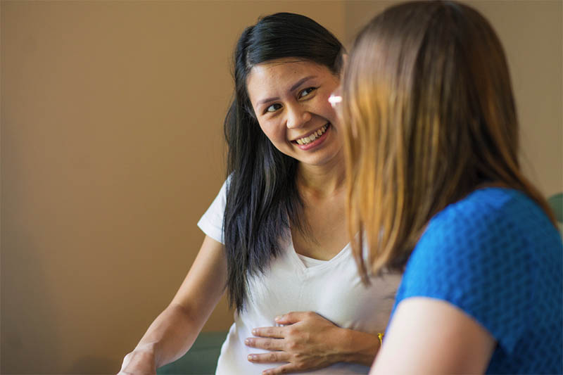 pregnant woman talks to a doula