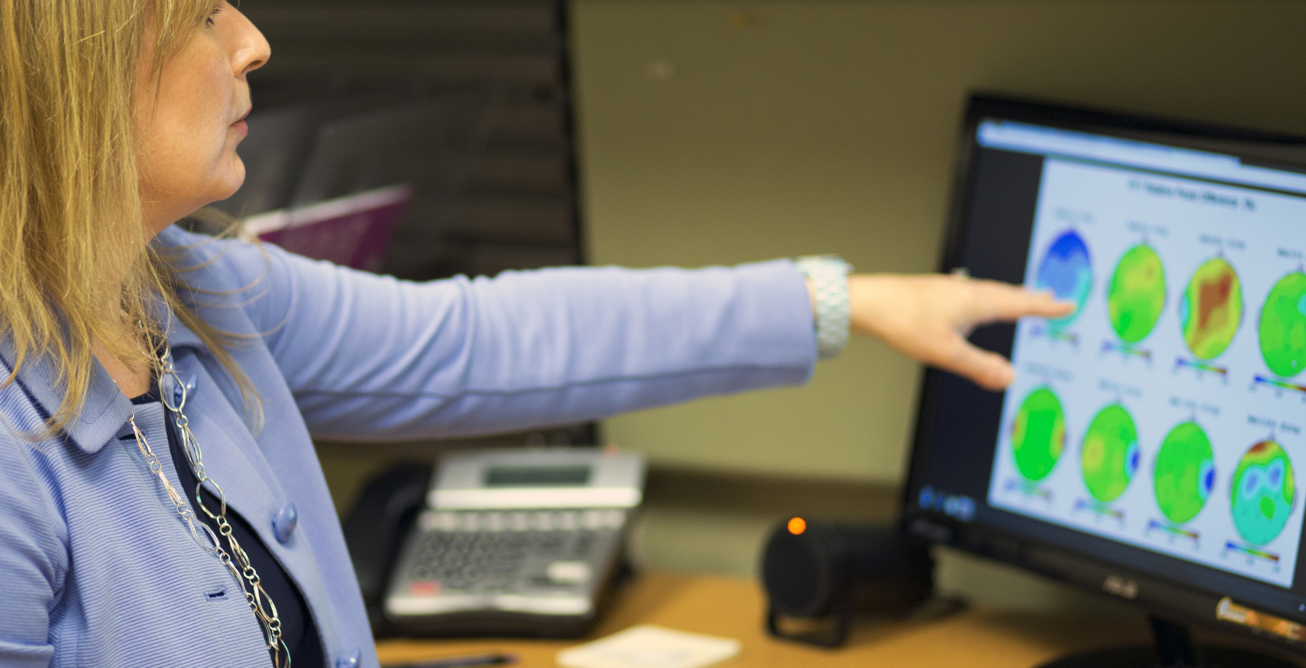 researcher pointing at a computer screen