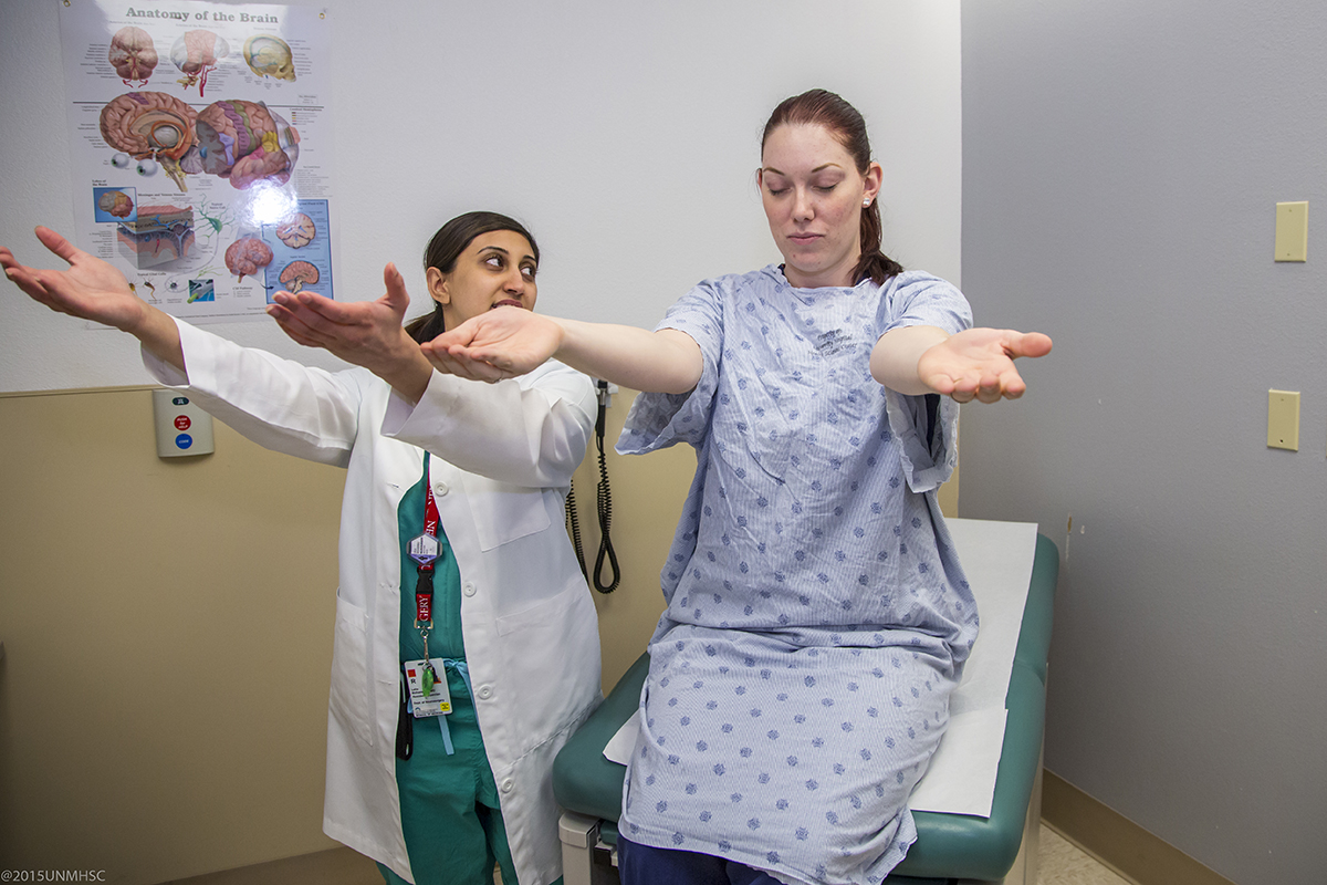 a female doctor and female patient perform neurological tests in a doctor's office
