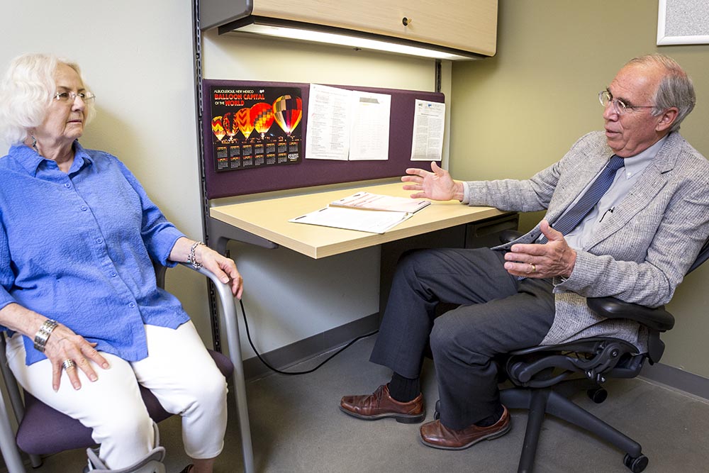 A neurologist talking to an older patient