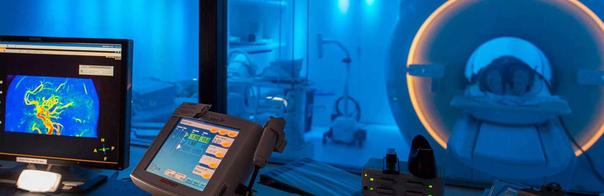 A desk with a computer controls an MRI machine in the rain