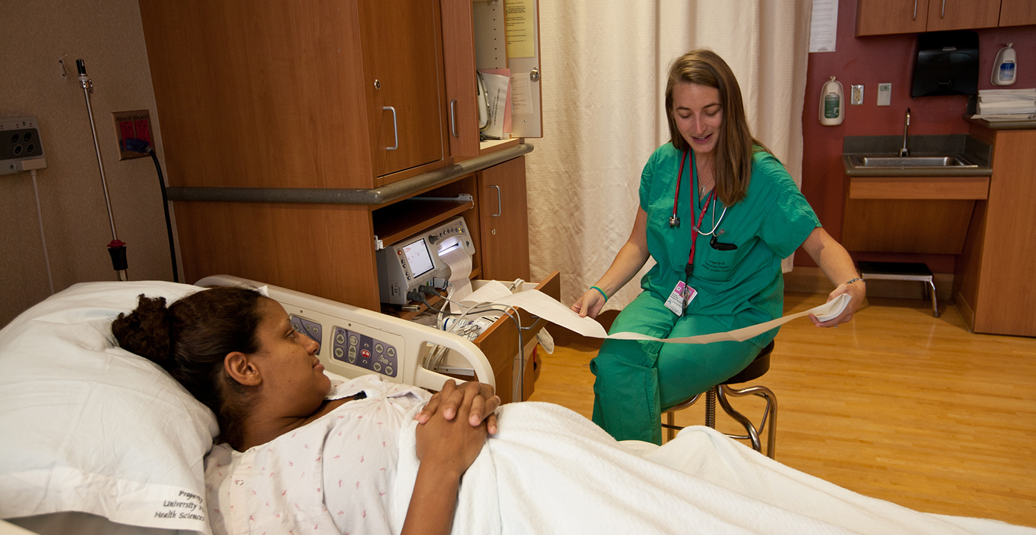 An expecting mother talking to a nurse