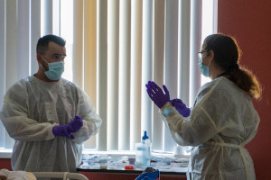 Doctor and neurology resident working in patient room.