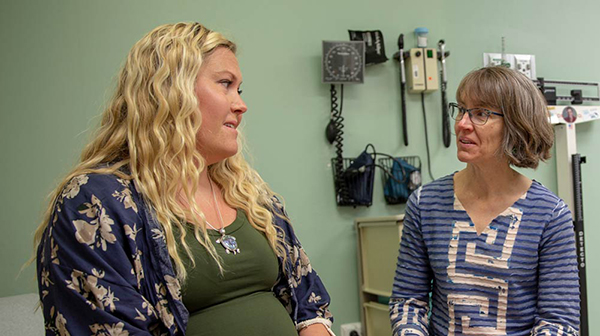 Woman talking to nurse