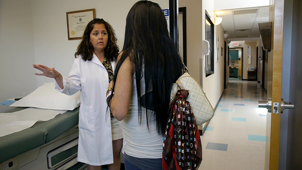 A medical professional talking to a patient