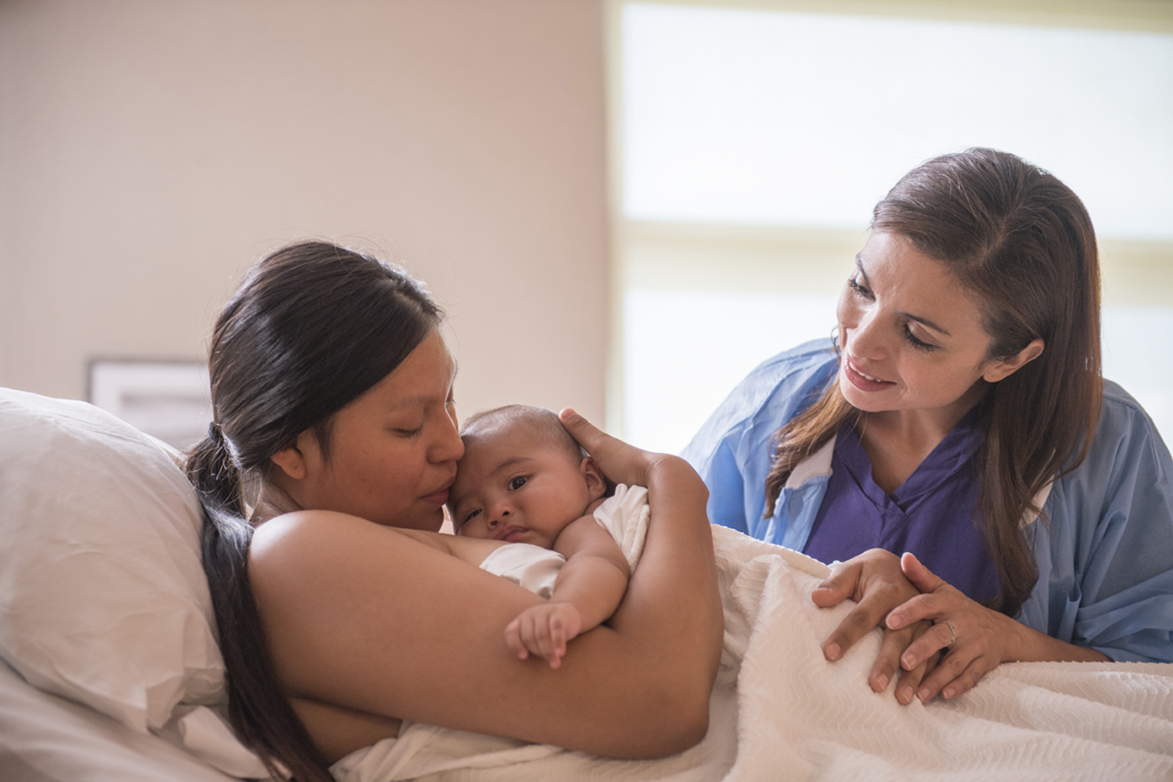 A nurse and a mother with her newborn